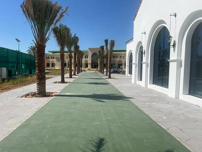 Hard landscaping and external works including paved walkways and palm tree landscaping by Osool AlRoyah General Contracting in the UAE