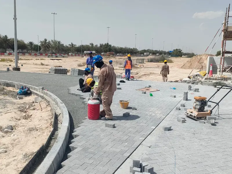 Kerbstone installation and interlock paving works for parking and road infrastructure by Osool AlRoyah General Contracting in the UAE